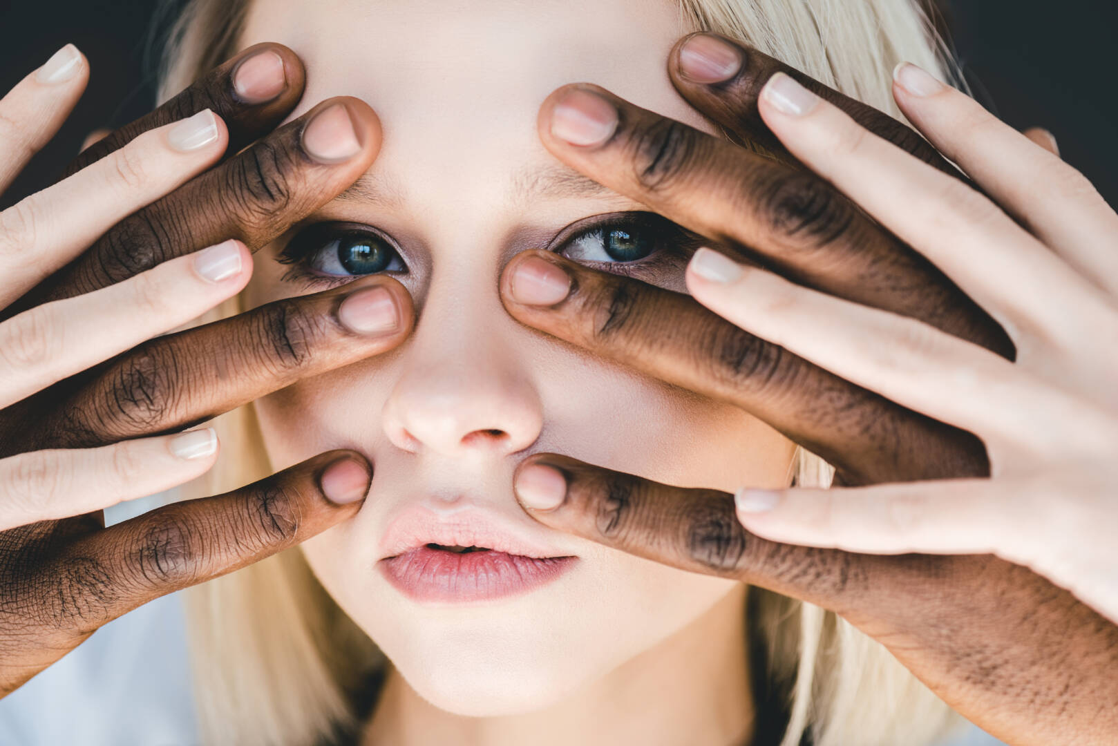 Cropped Image of African American Boyfriend touching Attractive Blonde Girlfriend Face Isolated on Black